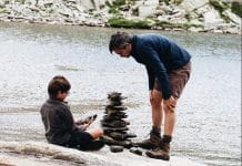 boy and man beside river during daytime