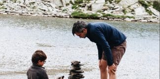 boy and man beside river during daytime